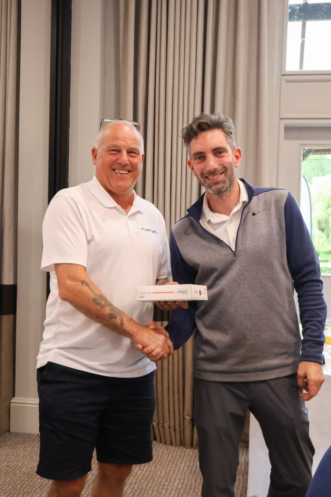 Competition winner receiving his award at the Golf Day